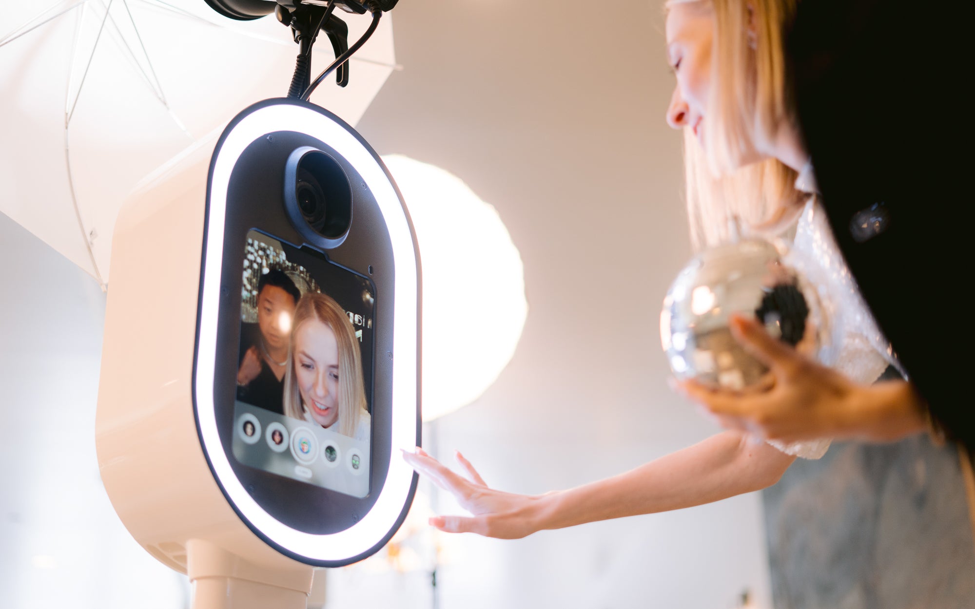 Smiling blonde woman taking a DSLR photo with the Guac photo booth at a wedding by Photobooth Supply Co.